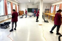 Studierende der Fachakademie reinigen einen Raum mit Einscheibenmaschinen